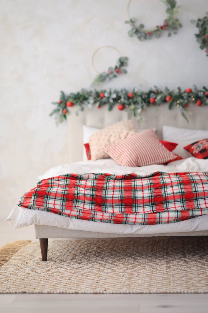 a picture of a bed decked with festive blankets and pillows