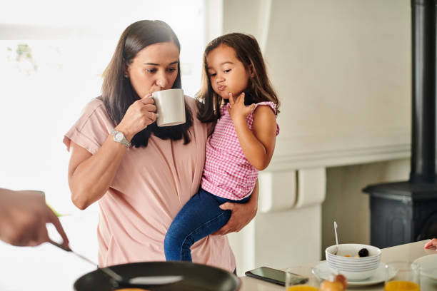 mom drinking coffee with her kid