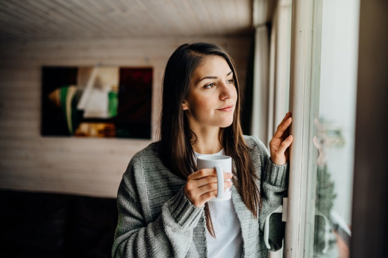 woman with good mental health, drinking coffee, happy serene