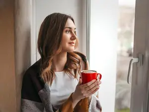 woman happy drinking a coffee practicing good mental healthy, happy, serene