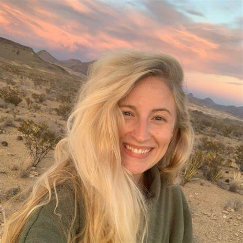 selfie of a woman in the desert with a sunset