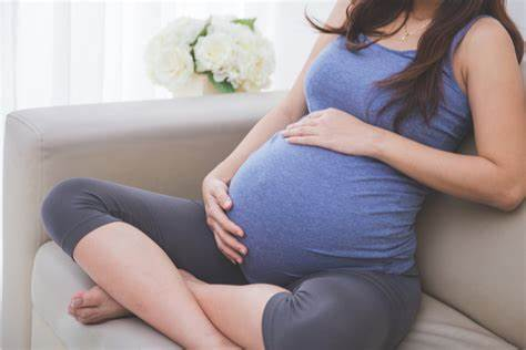 pregnant woman holding her belly