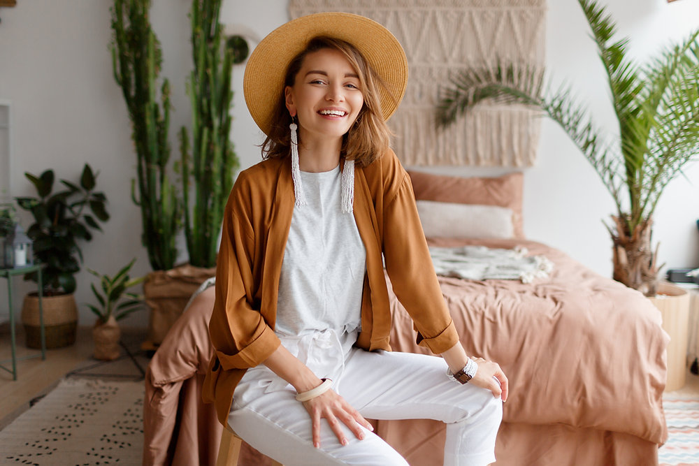 girl waking up happy in her boho bedroom