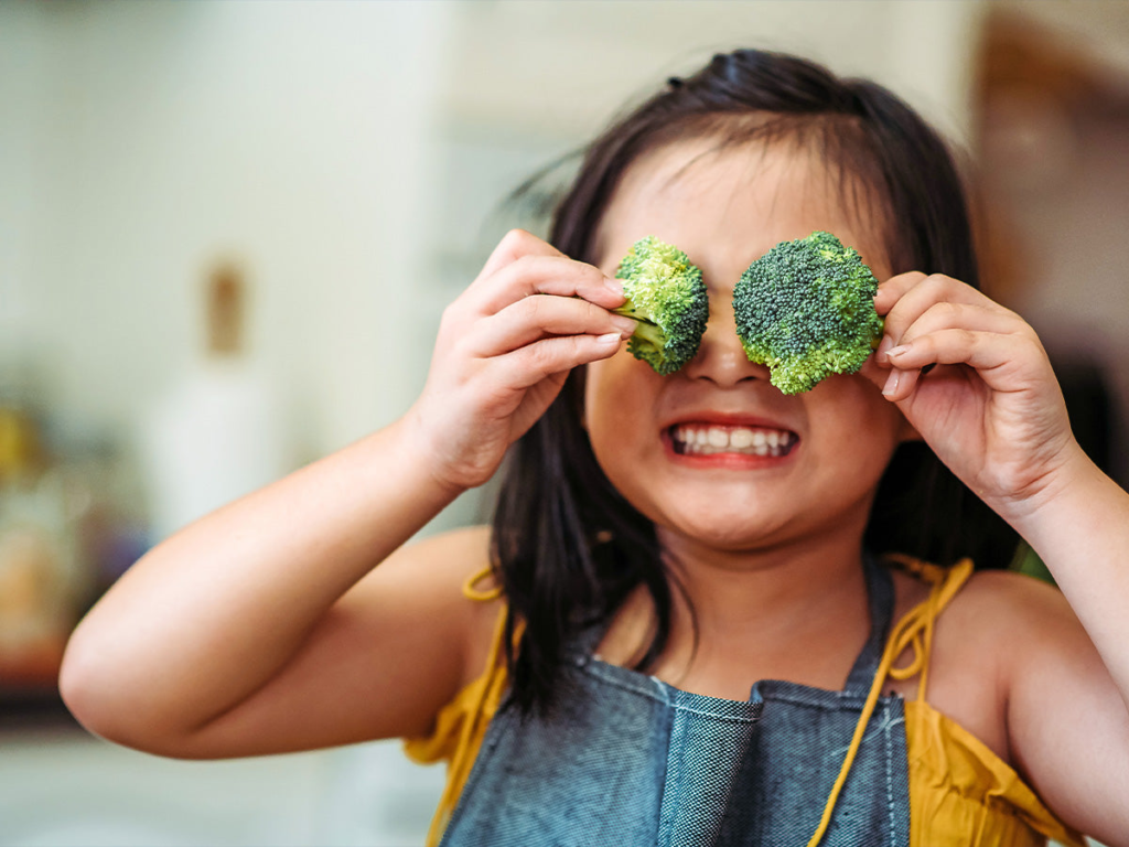 kid with broccoli on her eyes