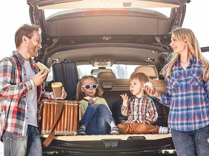 family eating snacks on a road trip